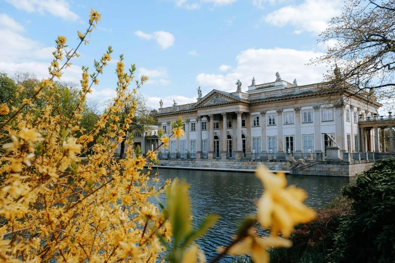 the building with long rooms is sitting over water