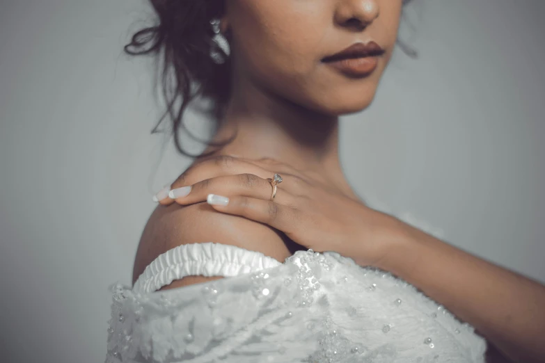 the back of a women's dress with her ring in it