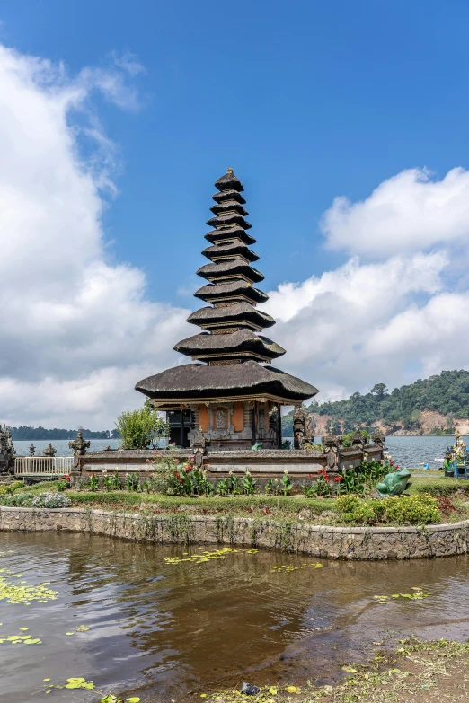 an image of the asian temple tower next to a body of water