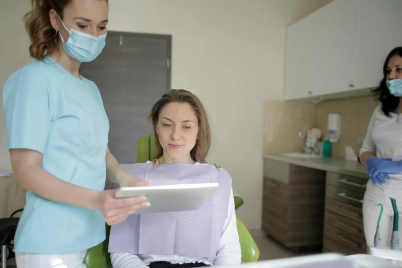 a woman wearing surgical gloves and having her hair cut