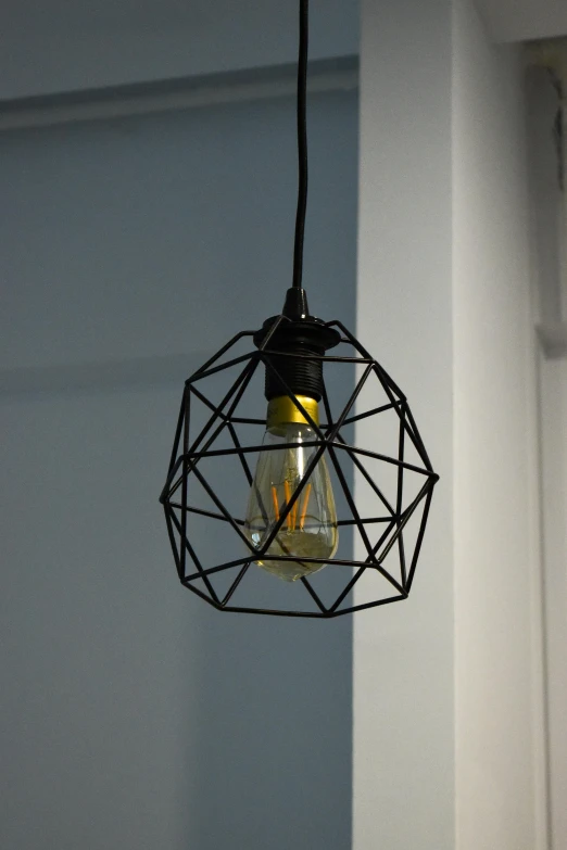 a wire bulb light hanging from a hook