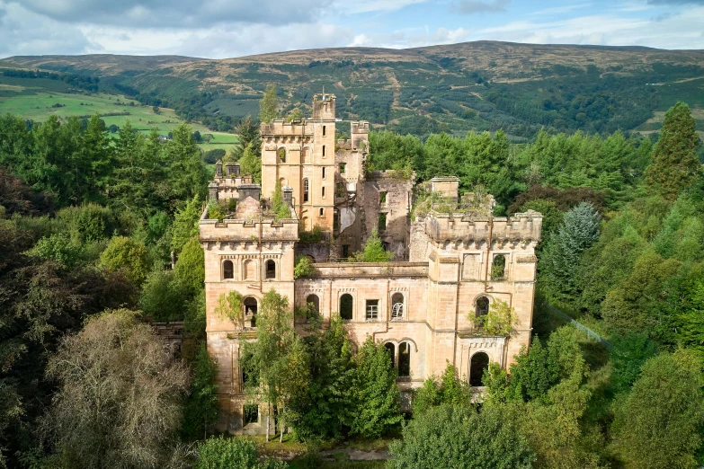 an old castle like building in the middle of trees