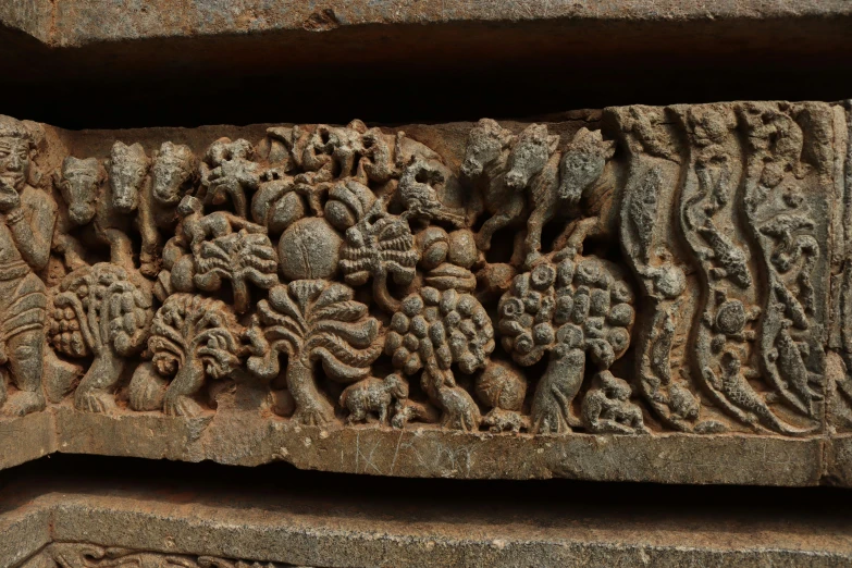 two carved stone sculptures with various figures on them