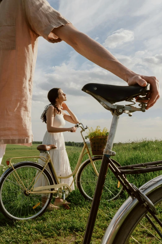 two people, one with a bicycle, looking at each other