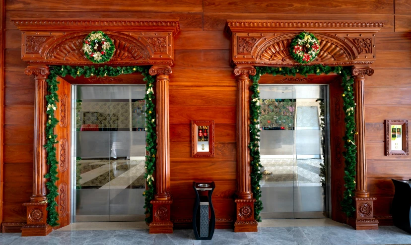 a christmas themed lobby has decorative wood doors