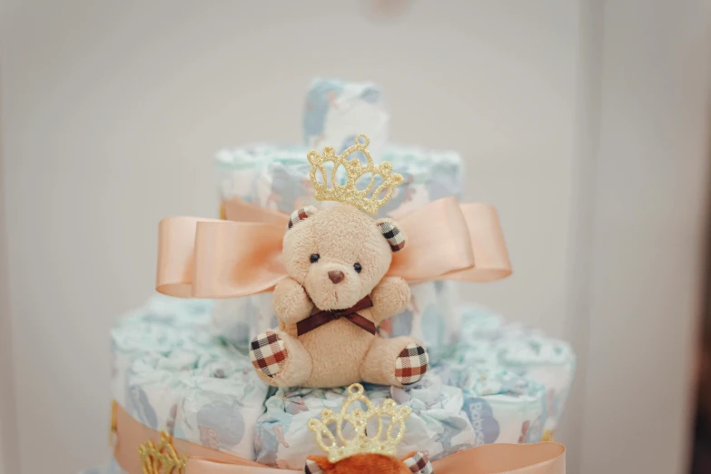 teddy bear with a crown on top of a baby carriage cake