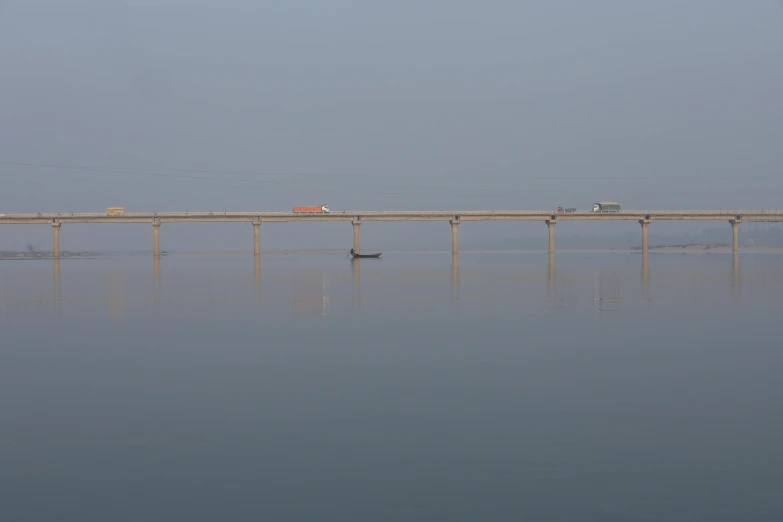 a long wooden bridge on top of a large body of water