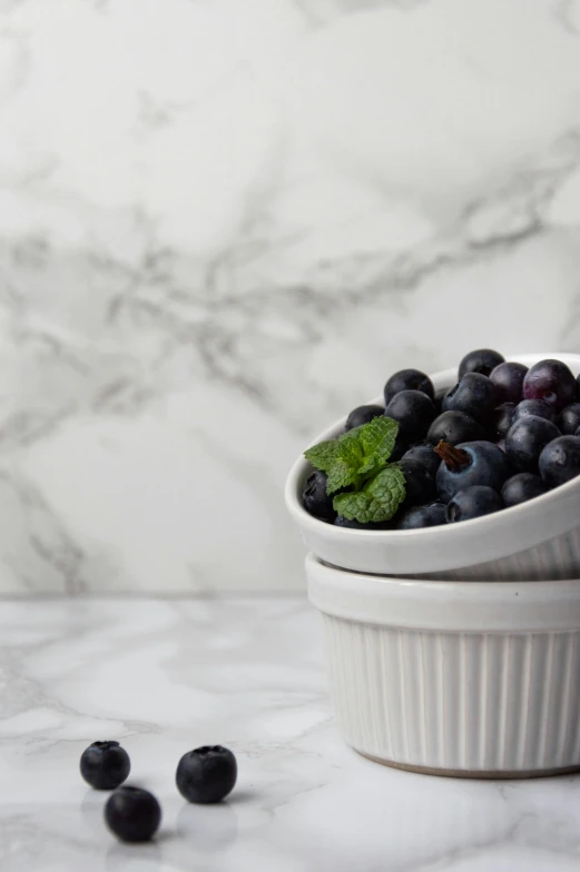 an apple, berry and mint covered pastry with marble table