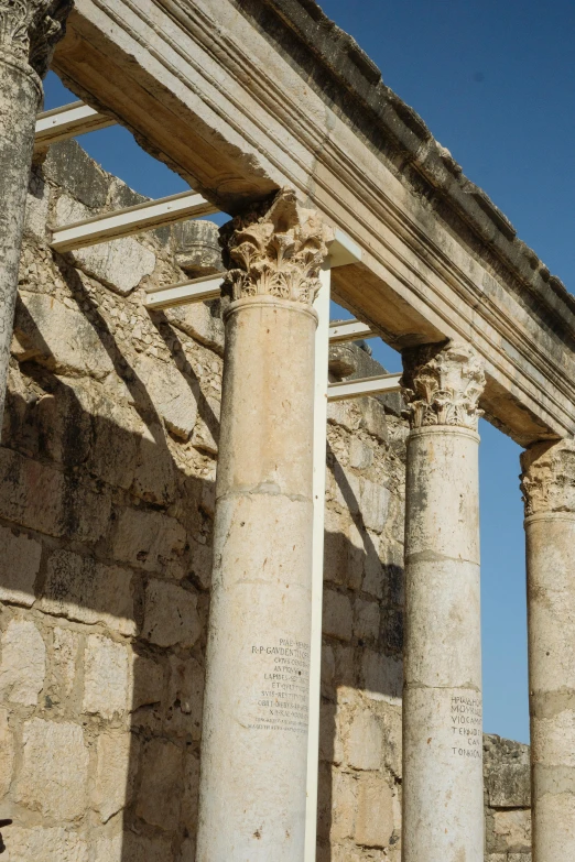 four large pillars of columns stand out against the blue sky