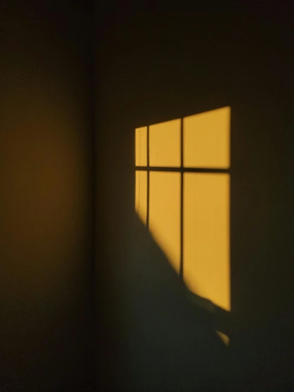 a small window shining in a dimly lit room