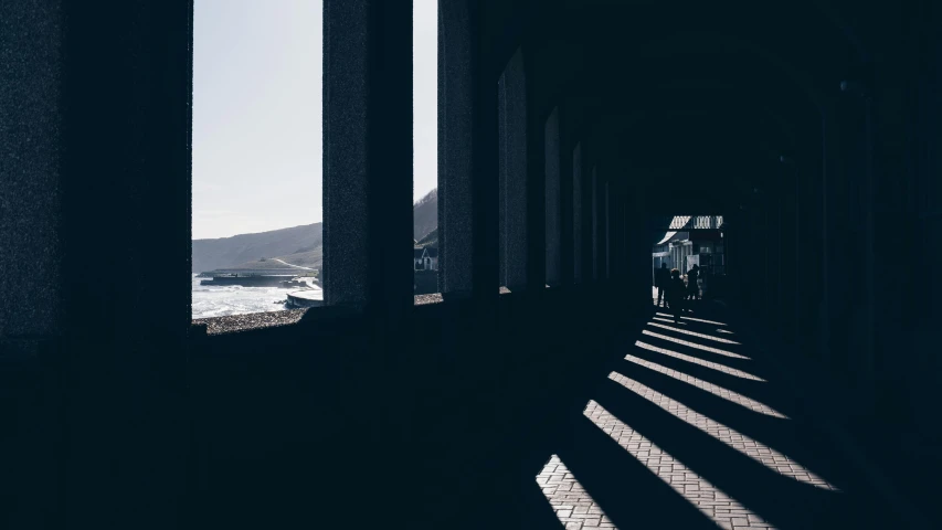 a black and white po of the sun shining on a long walkway