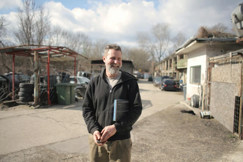 a man stands outside in the middle of the street