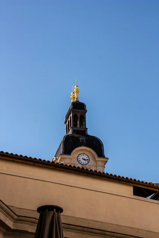 a clock and tower are visible atop a building