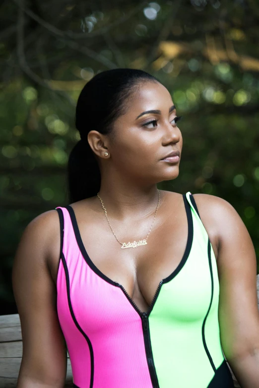 an african american woman with very large  wearing a neon colored dress