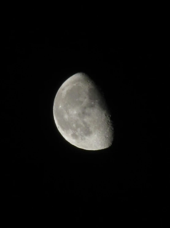 a half moon is seen in the night sky