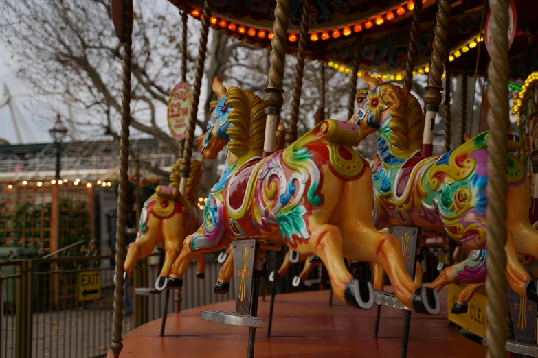 an image of an outside setting with animals on the merry go round