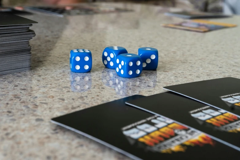 three blue dices are sitting on top of a table