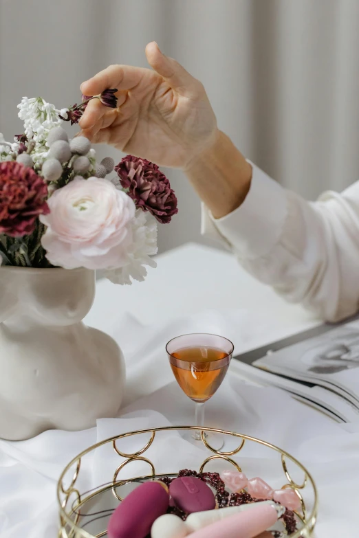 a table with a vase filled with white flowers