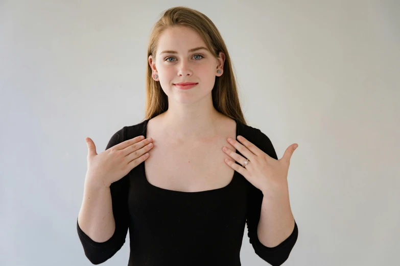 a woman in black shirt holding her hands together