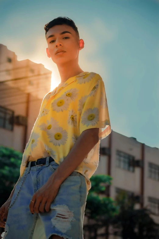 a boy wearing shorts and a yellow top