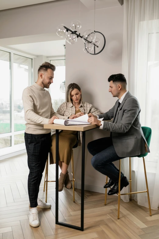 three men in a meeting room working on soing