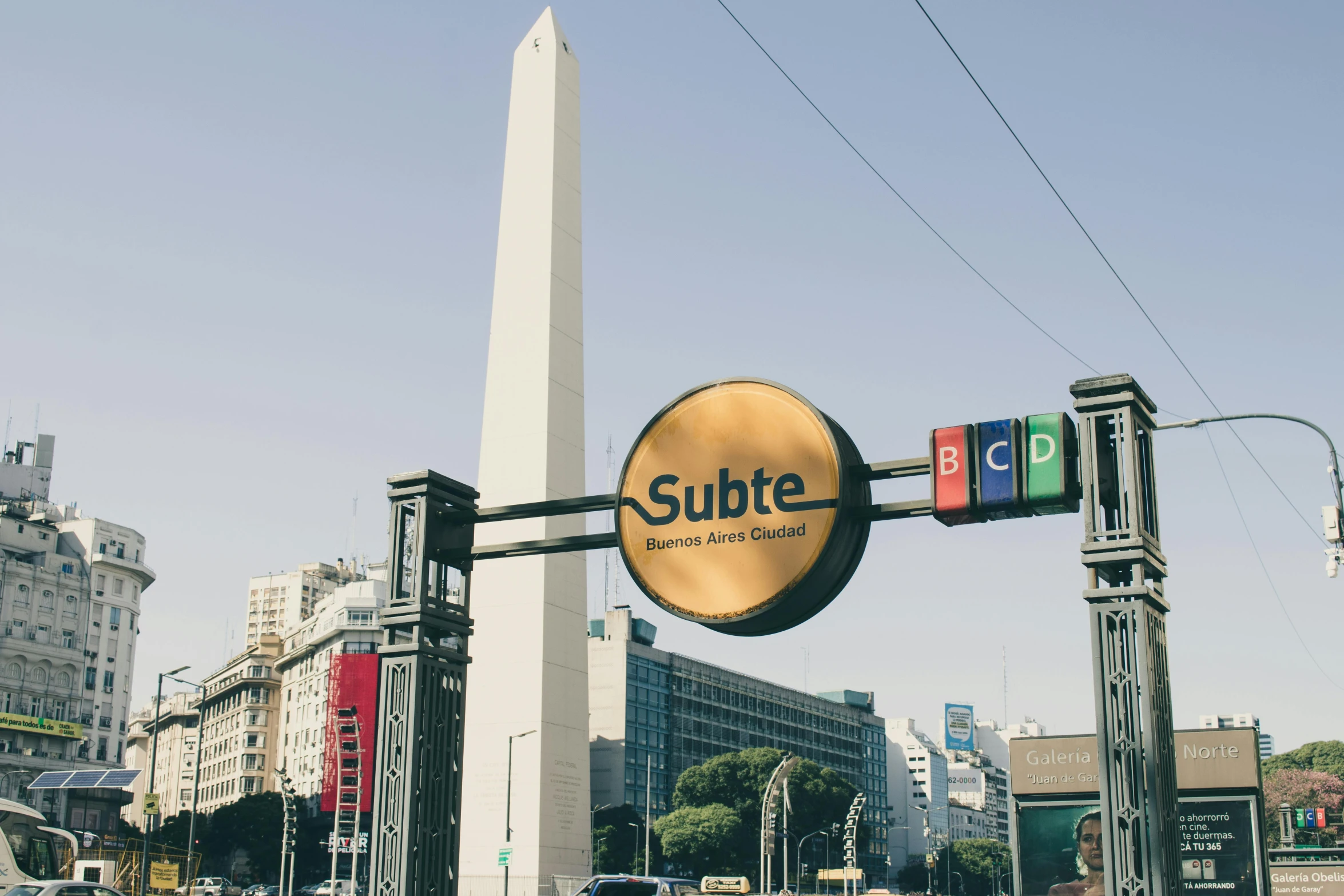 a street sign above a stop light with other traffic