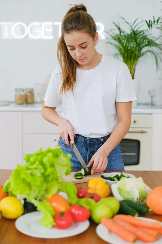 a beautiful young lady  a vegetable on a  board