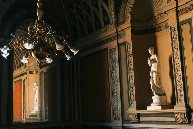 a chandelier hangs from the ceiling in an old, ornate room