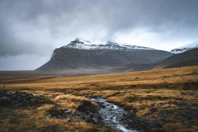 an icy mountain has snow on the top