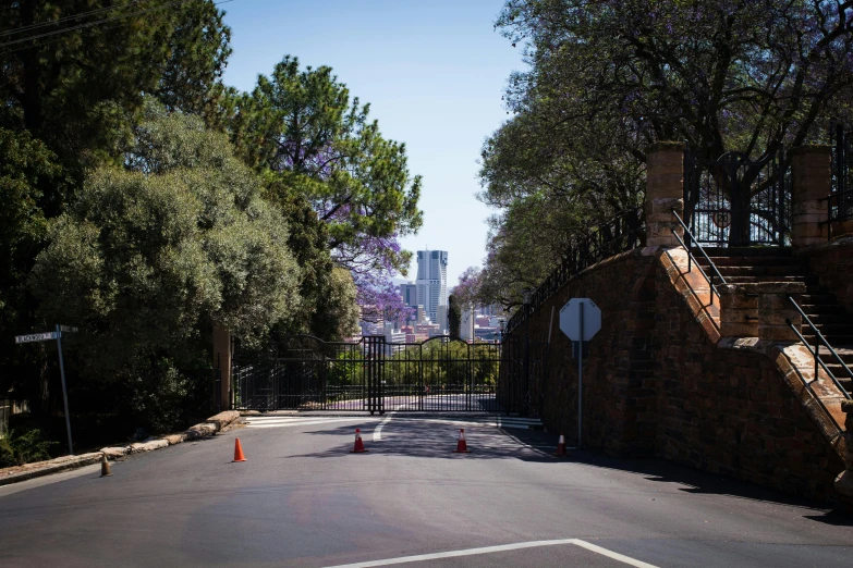 the entrance to a cemetery with orange cones on it