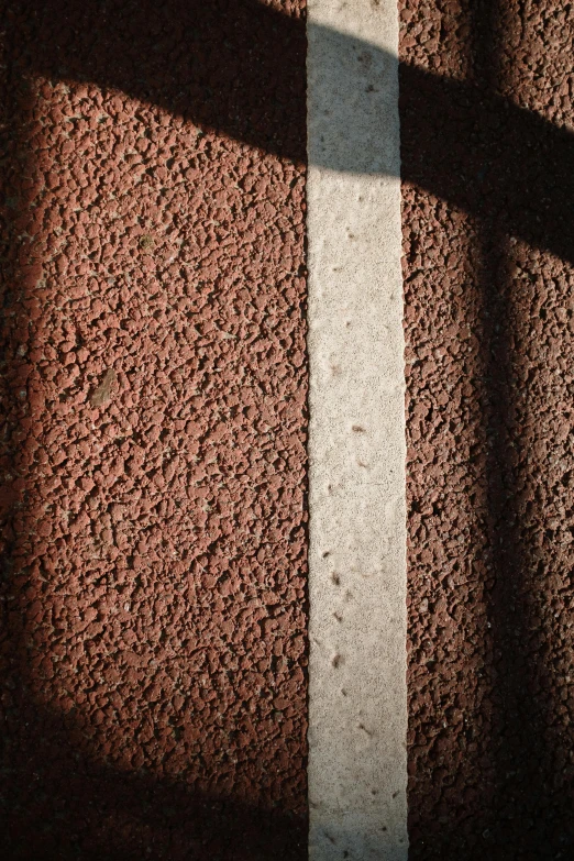 the shadow of a bench on a wall