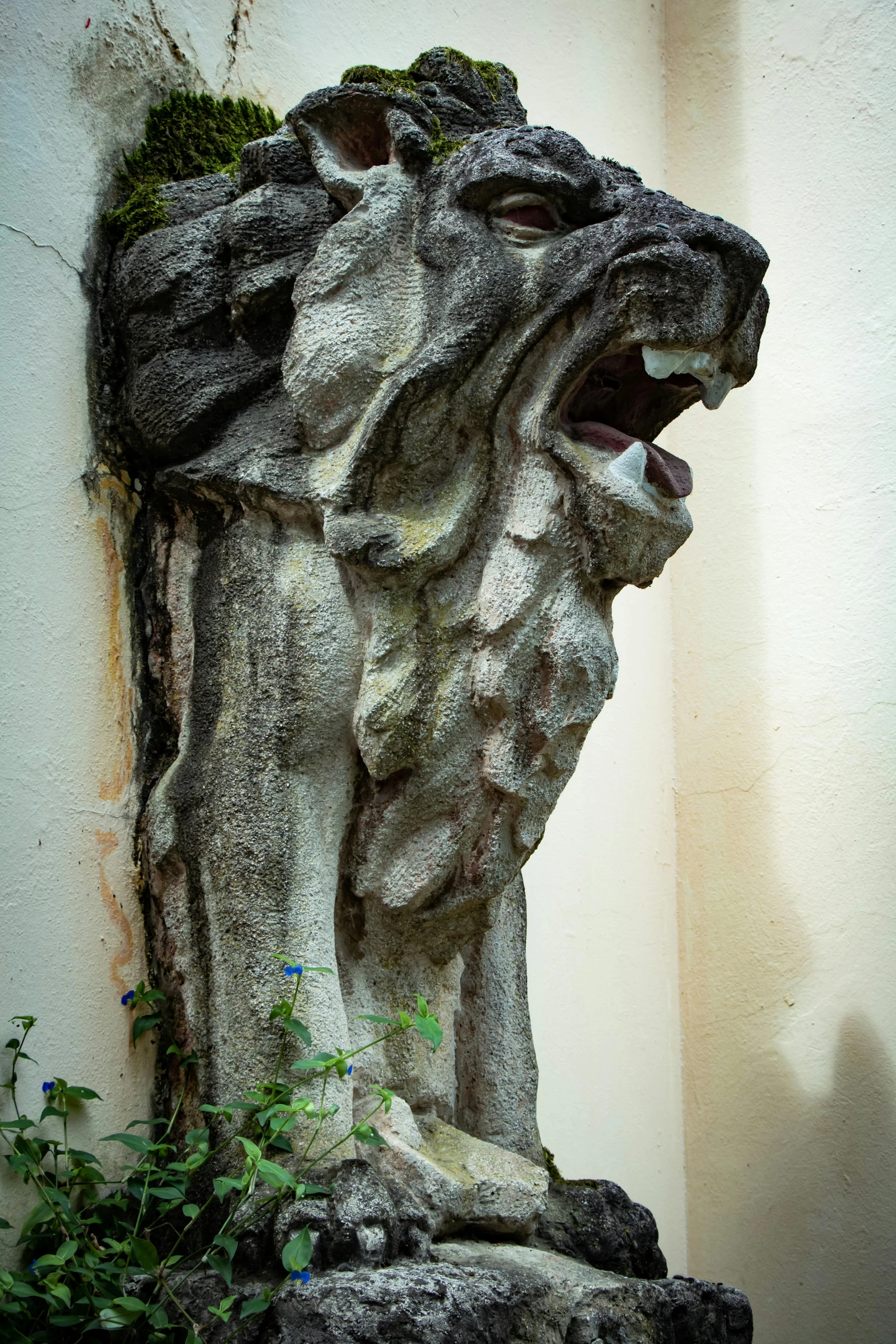 a small stone sculpture sitting on a side walk