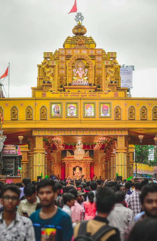 a crowd of people is outside of an entrance