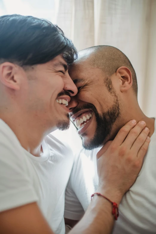 two men are smiling together while making silly faces