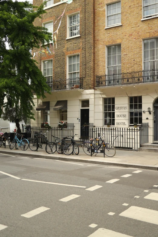 three bicycles parked on the outside of a building