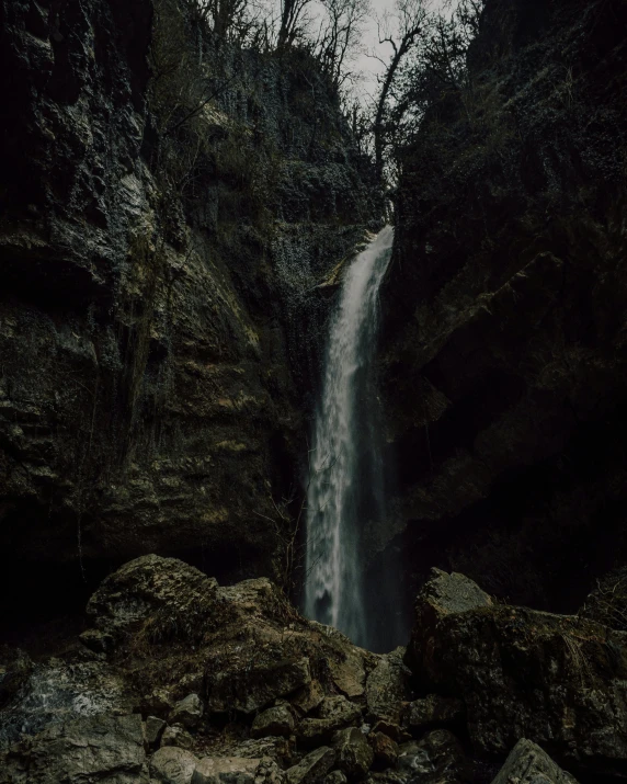 a large waterfall is in a rocky area