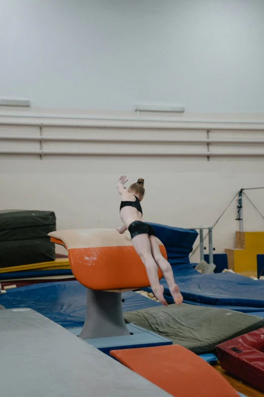 a woman performs a split on the trampoline