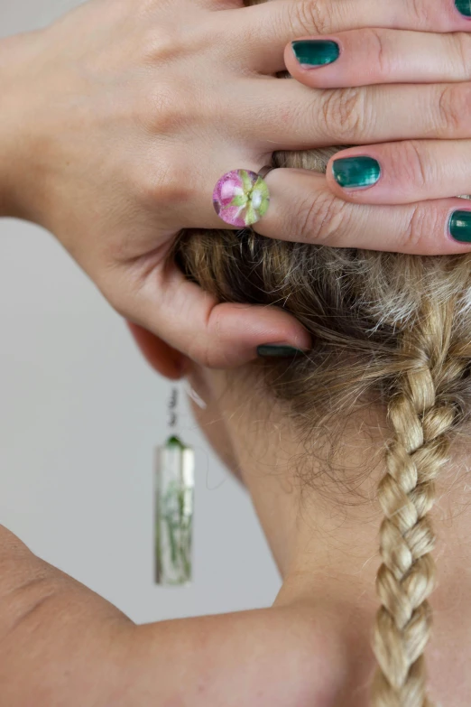 a close up of a person with green fingernails