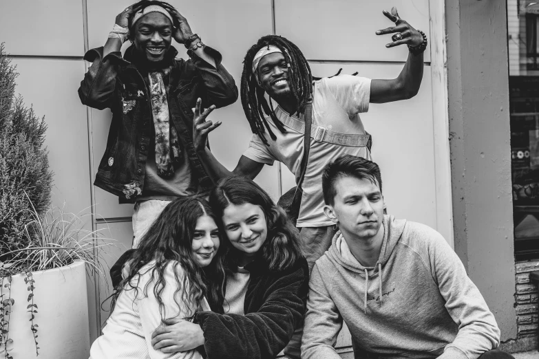 black and white pograph of group of men and women with one girl wearing a scarf