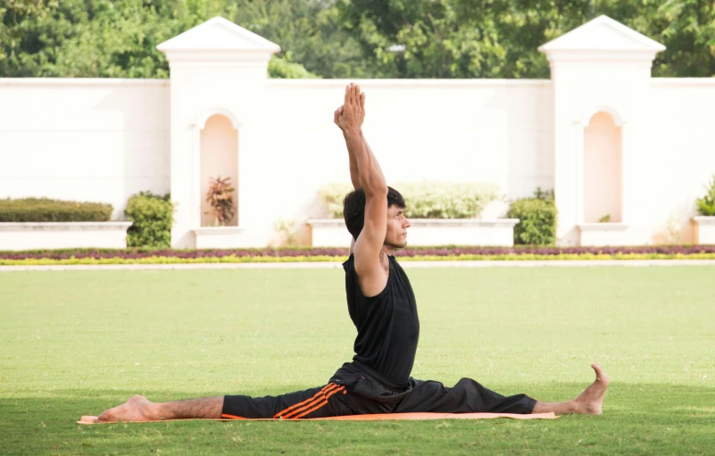 a man who is practicing yoga on a mat