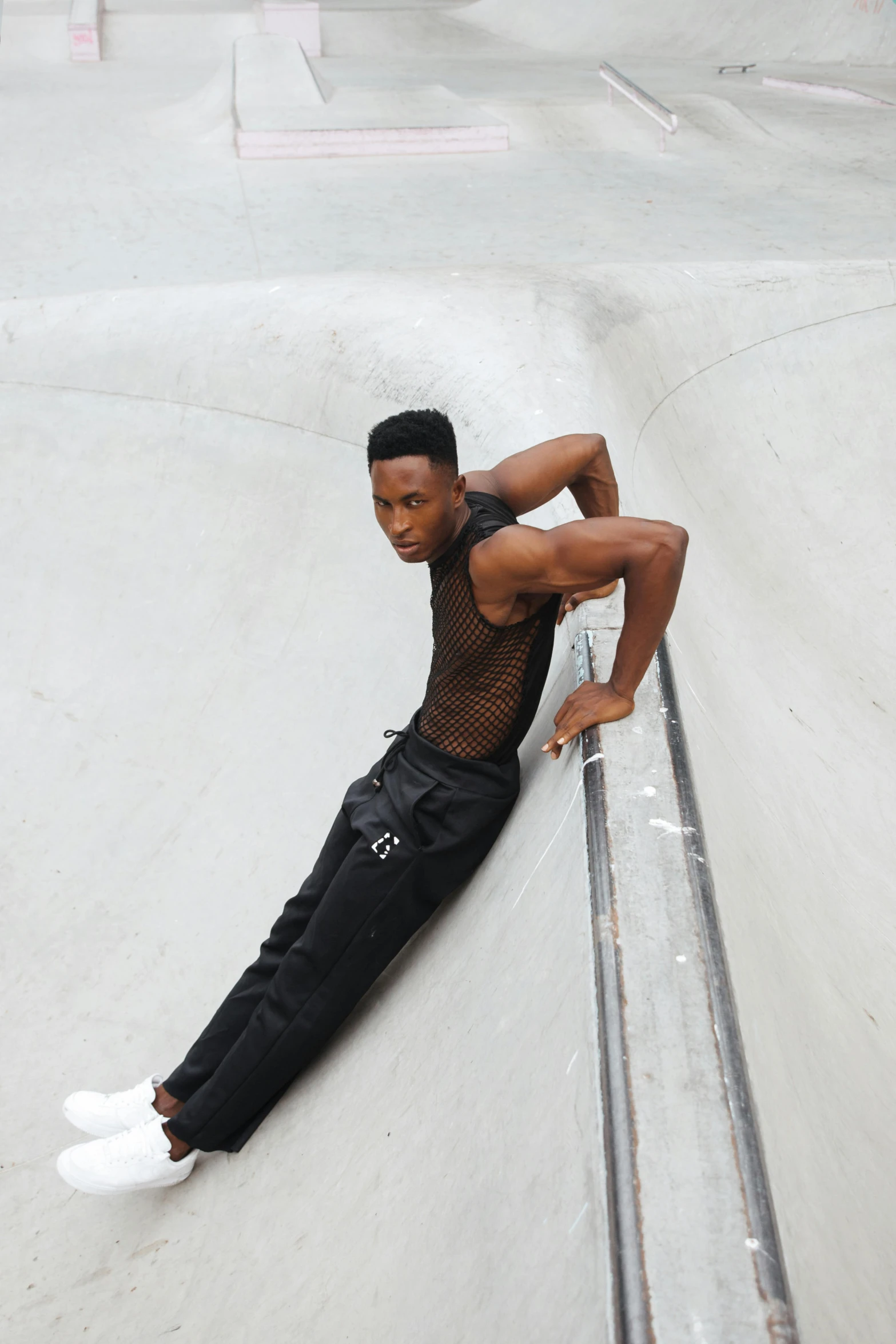 a young man standing on top of a skateboard ramp