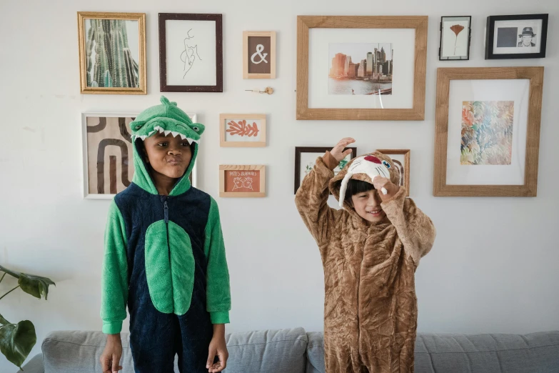 two young children dressed in costumes in a room