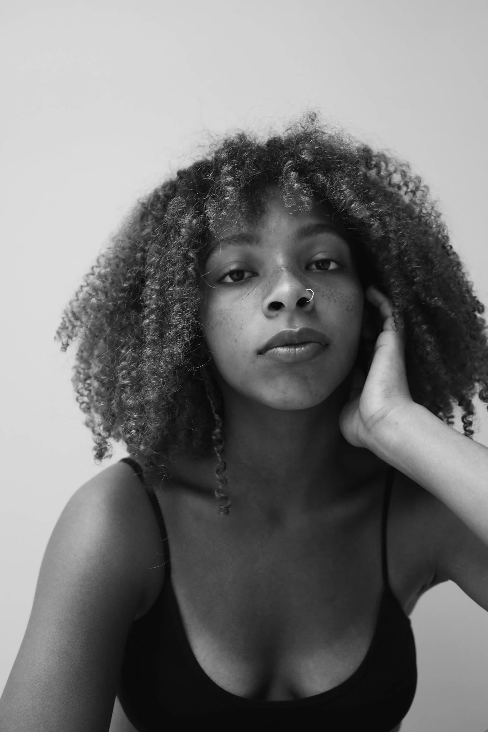 a woman posing for the camera in black and white