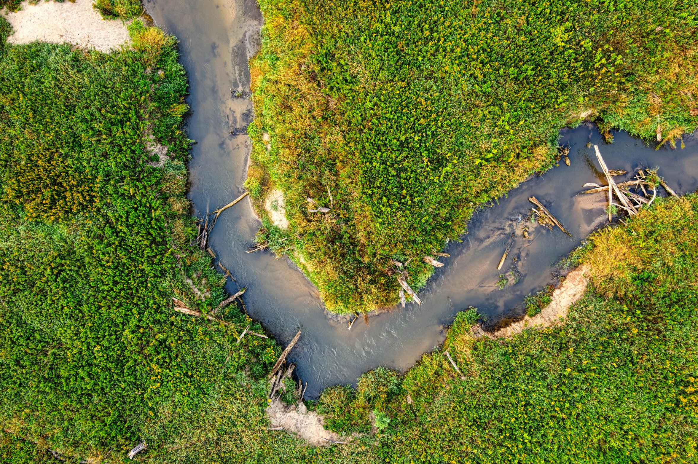 a bird's eye view of an intersection with a dirt road