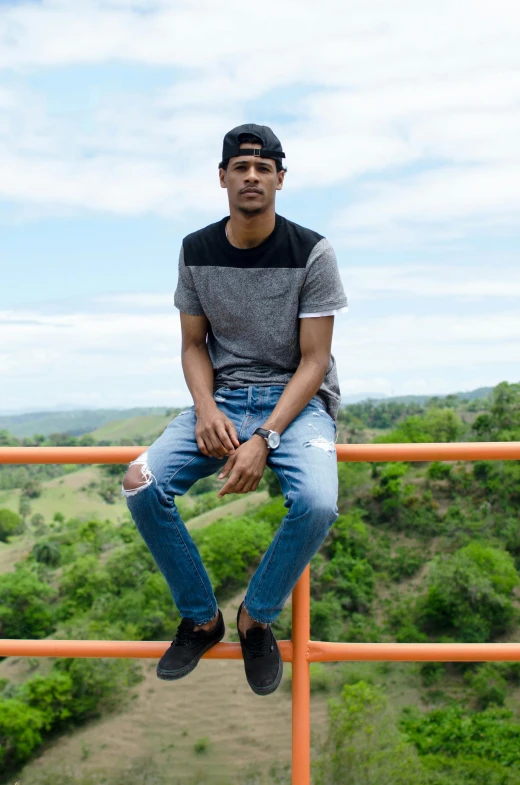 there is a young man sitting on the ledge