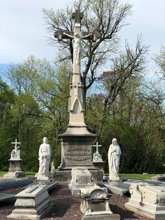 cemetery with statues and crucifix in the middle