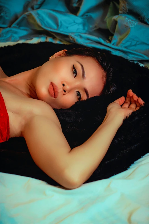 woman lying on bed with her arms folded