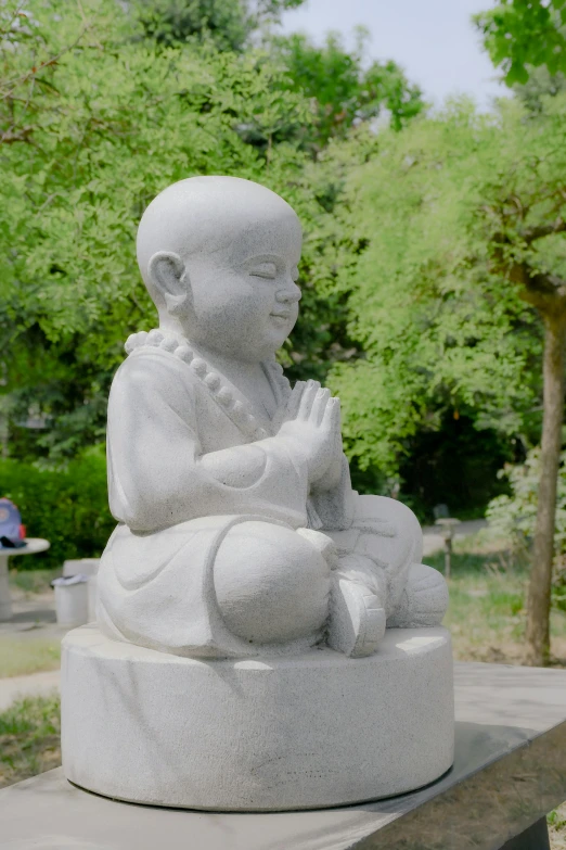 a white statue of a person with a praying position