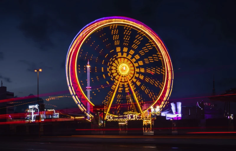 a ferris wheel that is light up during the night