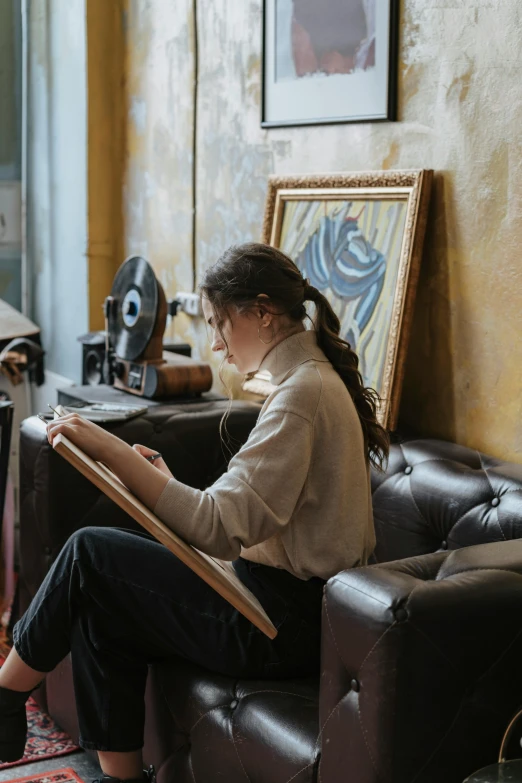 a girl sitting on a couch looking at soing